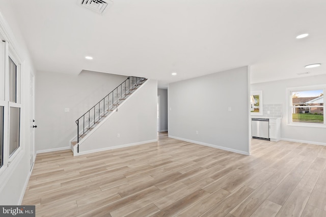 unfurnished living room featuring light wood-type flooring, recessed lighting, visible vents, and stairs