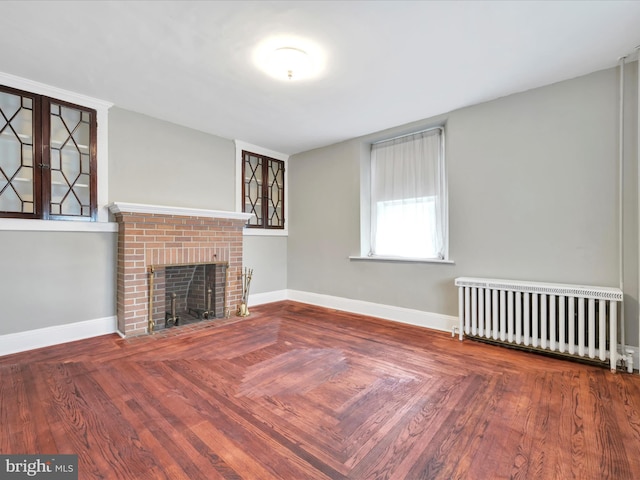 215 Biddle St, Gordon, PA 17936 - unfurnished living room featuring a fireplace, radiator heating unit, and baseboards