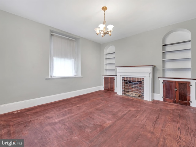 215 Biddle St, Gordon, PA 17936 - unfurnished living room with baseboards, a fireplace, built in features, and an inviting chandelier