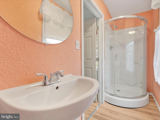 215 Biddle St, Gordon, PA 17936 - full bathroom featuring a textured wall, a stall shower, wood finished floors, and a sink