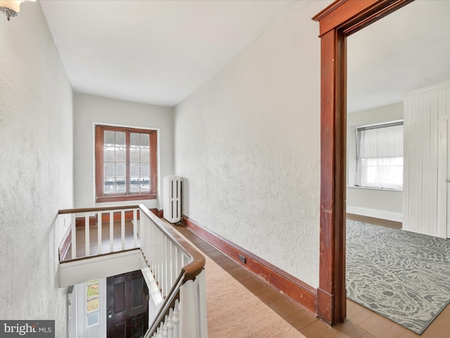 215 Biddle St, Gordon, PA 17936 - corridor featuring radiator, wood finished floors, baseboards, and a textured wall