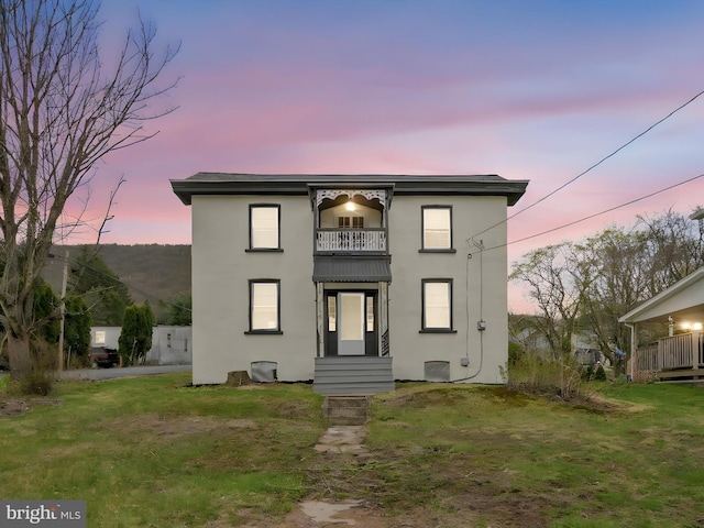 215 Biddle St, Gordon, PA 17936 - view of front of house featuring stucco siding, a lawn, and a balcony