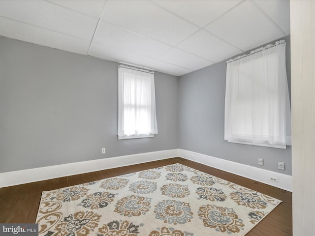 215 Biddle St, Gordon, PA 17936 - spare room featuring baseboards, a drop ceiling, and dark wood-style floors