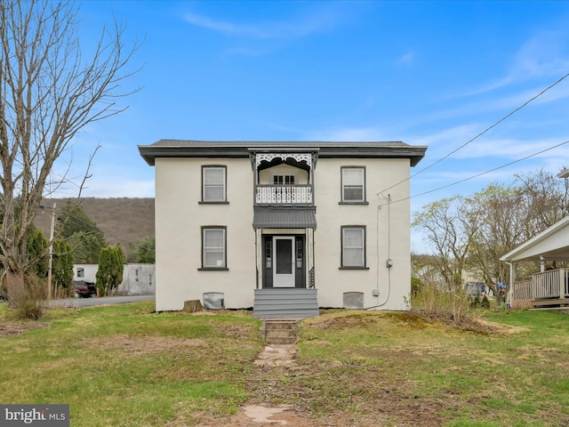 215 Biddle St, Gordon, PA 17936 - view of front facade featuring a balcony, a front yard, and stucco siding