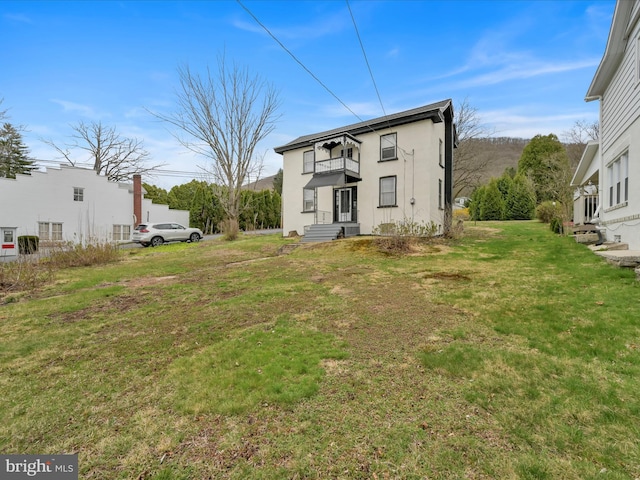 215 Biddle St, Gordon, PA 17936 - back of house with a lawn, a balcony, and stucco siding