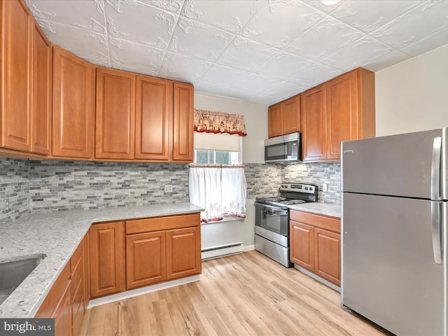215 Biddle St, Gordon, PA 17936 - kitchen with light wood finished floors, baseboard heating, brown cabinets, and appliances with stainless steel finishes