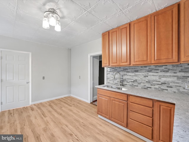 215 Biddle St, Gordon, PA 17936 - kitchen with brown cabinets, tasteful backsplash, and a sink