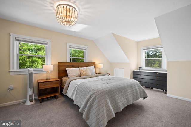 carpeted bedroom with baseboards, an inviting chandelier, multiple windows, and lofted ceiling