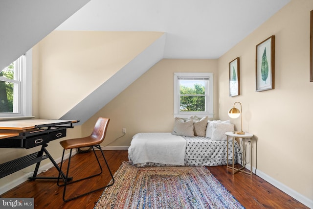 bedroom featuring baseboards, vaulted ceiling, and wood finished floors