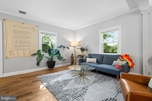 sitting room featuring plenty of natural light, crown molding, and visible vents