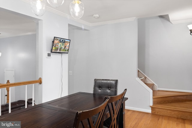 dining area with light wood-type flooring, baseboards, stairway, and crown molding