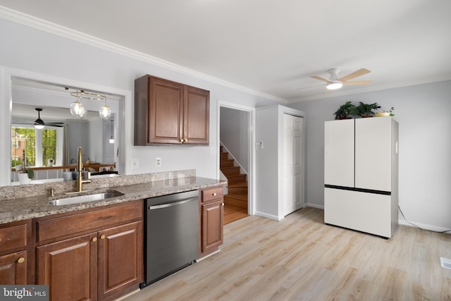 kitchen with stainless steel dishwasher, a ceiling fan, a sink, and freestanding refrigerator