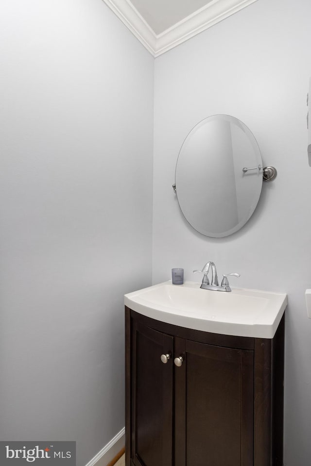 bathroom with crown molding and vanity