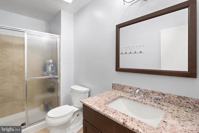 full bathroom featuring vanity, toilet, and a stall shower