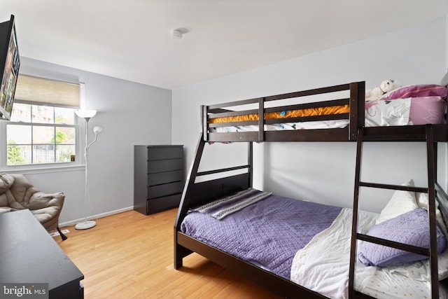 bedroom featuring light wood-type flooring and baseboards