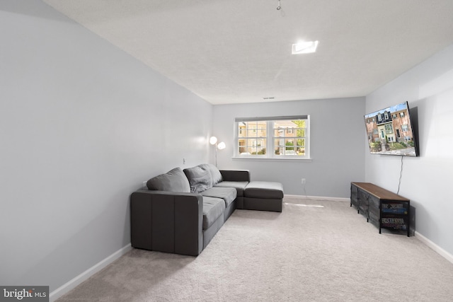 carpeted living area with baseboards