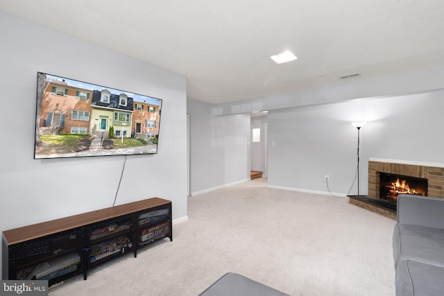 unfurnished living room with a brick fireplace, carpet flooring, baseboards, and visible vents