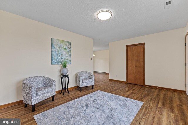 392 Walker Way, Timberville, VA 22853 - sitting room with wood finished floors, baseboards, a textured ceiling, and a baseboard heating unit