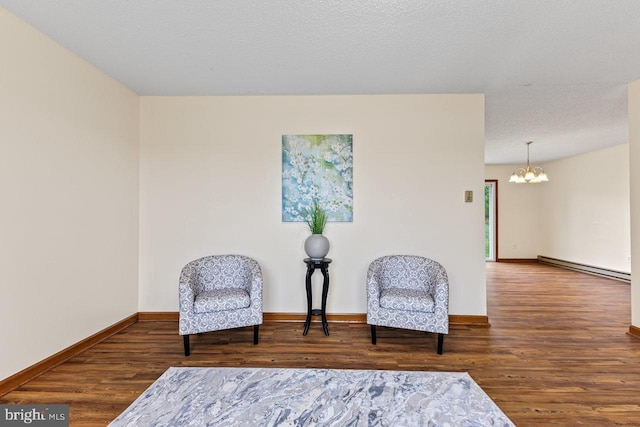 392 Walker Way, Timberville, VA 22853 - living area featuring a baseboard heating unit, a chandelier, wood finished floors, and baseboards