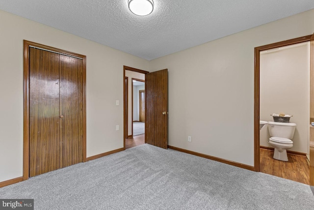 392 Walker Way, Timberville, VA 22853 - bedroom featuring carpet, a textured ceiling, a closet, baseboards, and connected bathroom