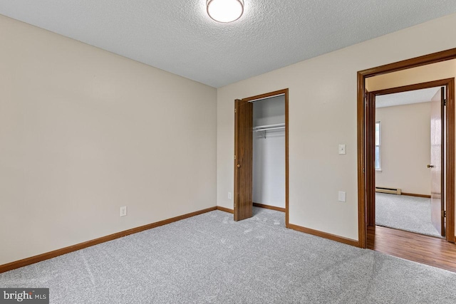 392 Walker Way, Timberville, VA 22853 - unfurnished bedroom with a baseboard heating unit, carpet floors, baseboards, a closet, and a textured ceiling