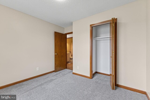 392 Walker Way, Timberville, VA 22853 - unfurnished bedroom with carpet floors, a closet, baseboards, and a textured ceiling