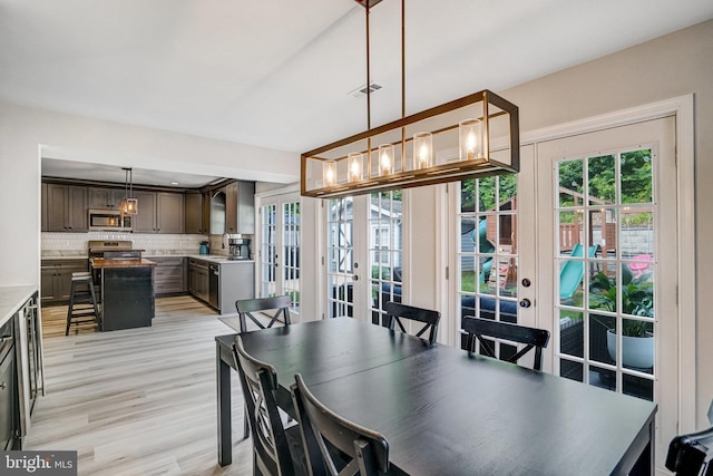 6022 Rixey Dr, Alexandria, VA 22303 - dining room featuring french doors, a chandelier, and light wood-type flooring