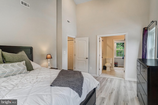 6022 Rixey Dr, Alexandria, VA 22303 - bedroom with light wood-style flooring, a towering ceiling, and ensuite bathroom
