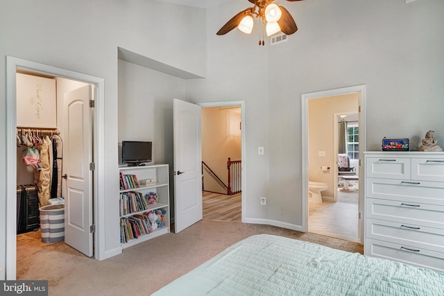 6022 Rixey Dr, Alexandria, VA 22303 - bedroom with light carpet, a spacious closet, a towering ceiling, ensuite bathroom, and a closet