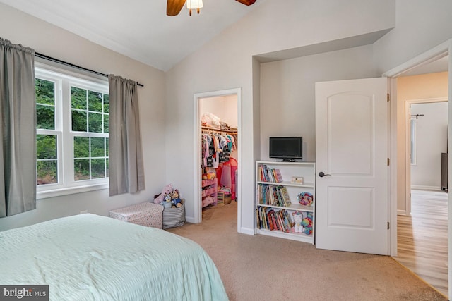 6022 Rixey Dr, Alexandria, VA 22303 - carpeted bedroom featuring vaulted ceiling, a walk in closet, a closet, and a ceiling fan