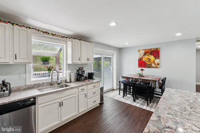 8412 Impalla Dr, Manassas, VA 20110 - kitchen with stainless steel dishwasher, a sink, dark wood-style flooring, white cabinets, and recessed lighting