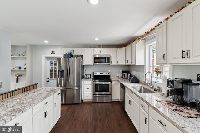 8412 Impalla Dr, Manassas, VA 20110 - kitchen with appliances with stainless steel finishes, a sink, white cabinets, dark wood-style flooring, and recessed lighting