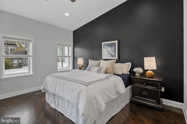 bedroom with recessed lighting, dark wood finished floors, lofted ceiling, and baseboards