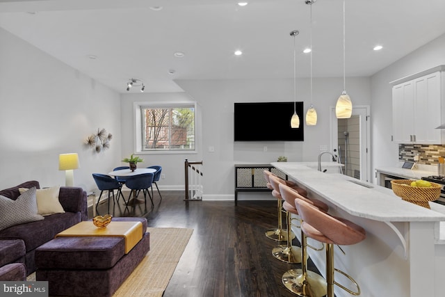 interior space with dark wood-style floors, recessed lighting, and baseboards