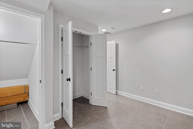 unfurnished bedroom featuring baseboards, recessed lighting, and tile patterned floors