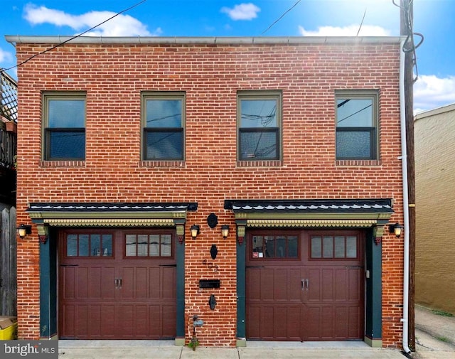 view of front facade with a garage and brick siding