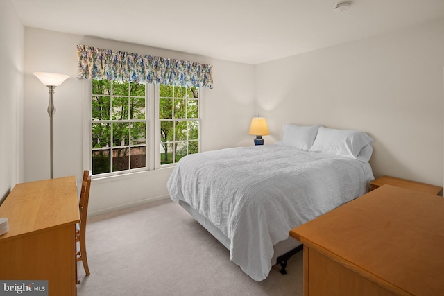 carpeted bedroom featuring baseboards