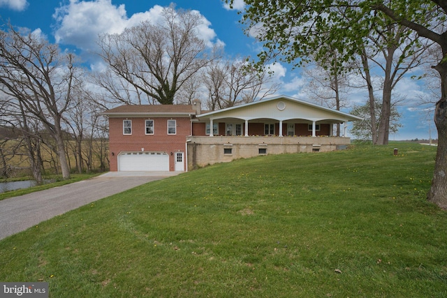 17634 Bruehl Rd, Upperco, MD 21155 - view of front facade with a front yard, an attached garage, brick siding, and concrete driveway