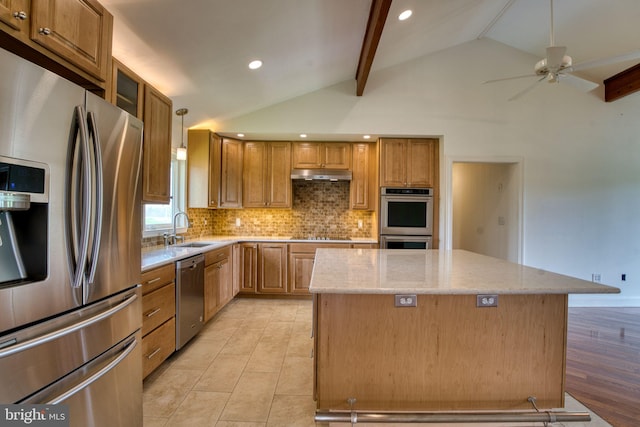 17634 Bruehl Rd, Upperco, MD 21155 - kitchen with appliances with stainless steel finishes, a center island, under cabinet range hood, a ceiling fan, and decorative backsplash