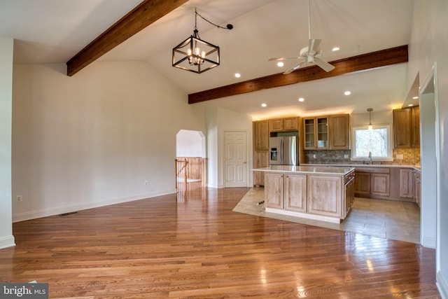 17634 Bruehl Rd, Upperco, MD 21155 - kitchen with beam ceiling, stainless steel refrigerator with ice dispenser, a center island, light wood-type flooring, and a ceiling fan