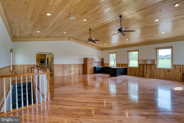 17634 Bruehl Rd, Upperco, MD 21155 - unfurnished living room with a wainscoted wall, wooden walls, light wood-style flooring, crown molding, and a ceiling fan
