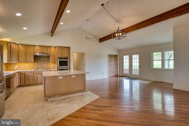 17634 Bruehl Rd, Upperco, MD 21155 - kitchen with under cabinet range hood, stainless steel double oven, light countertops, a ceiling fan, and a center island
