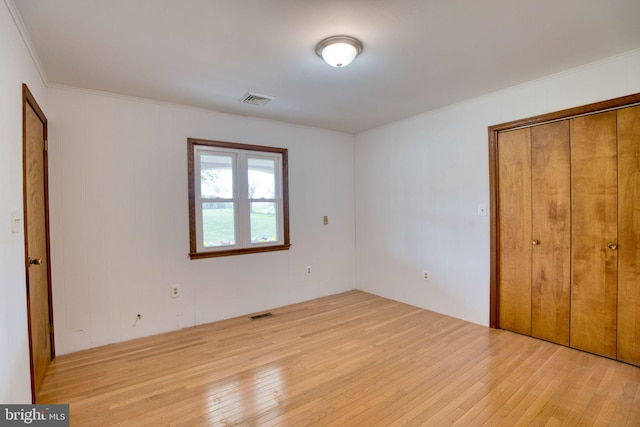 17634 Bruehl Rd, Upperco, MD 21155 - unfurnished bedroom featuring hardwood / wood-style flooring, crown molding, and a closet