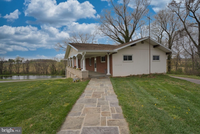 17634 Bruehl Rd, Upperco, MD 21155 - view of front facade with a water view, a front lawn, a porch, and brick siding