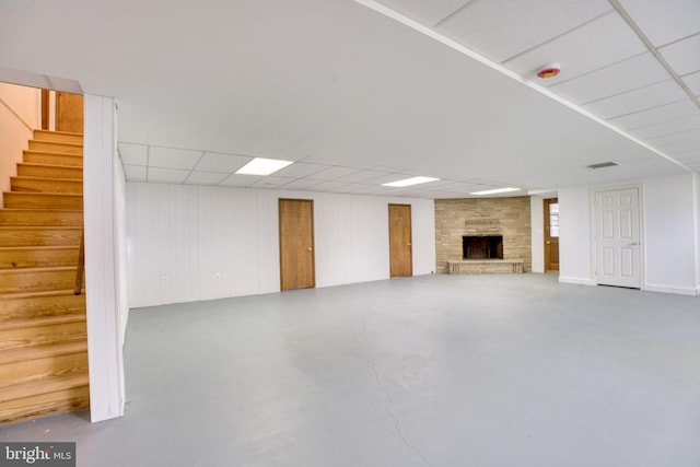 17634 Bruehl Rd, Upperco, MD 21155 - unfurnished living room featuring stairway, concrete flooring, a large fireplace, and a paneled ceiling