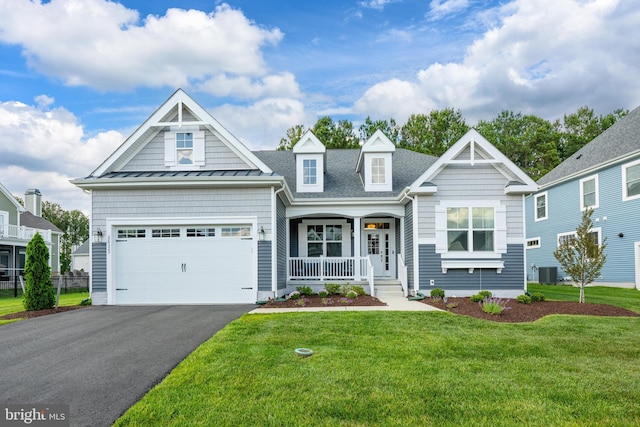 26325 Tributary Blvd, Millsboro, DE 19966 - view of front of house featuring covered porch, driveway, a front yard, a standing seam roof, and cooling unit
