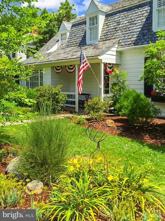 view of front of house with a high end roof and covered porch