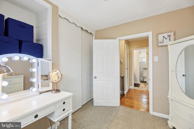 interior space featuring baseboards and light colored carpet