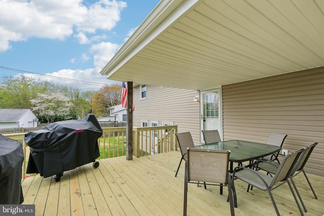 deck featuring outdoor dining space and area for grilling