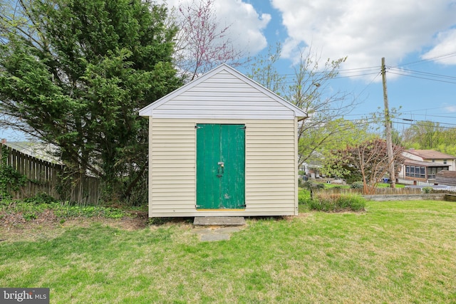 view of shed featuring fence